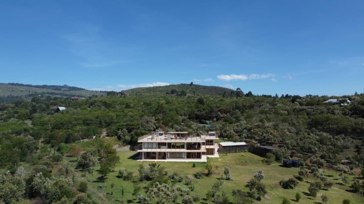 La Maison Bleue Naivasha — aerial view of the house nestled in green hills
