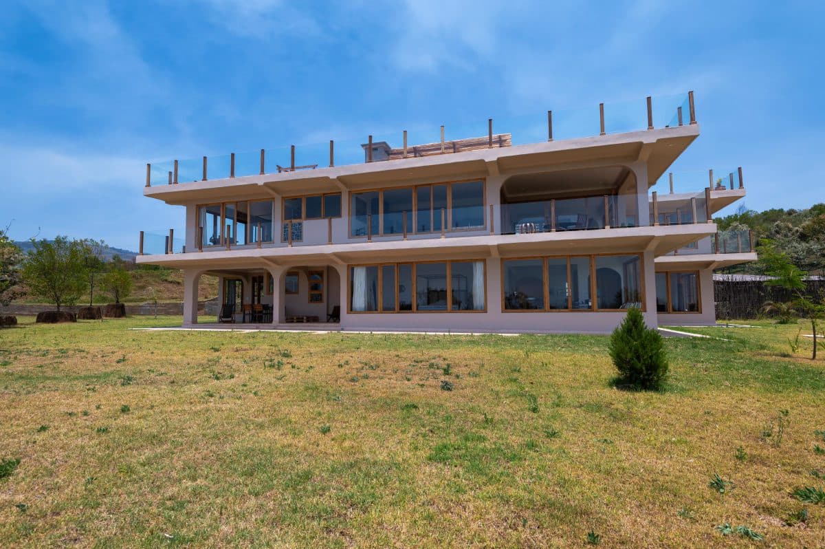 La Maison Bleue Naivasha — house façade with wraparound balconies facing the lawn