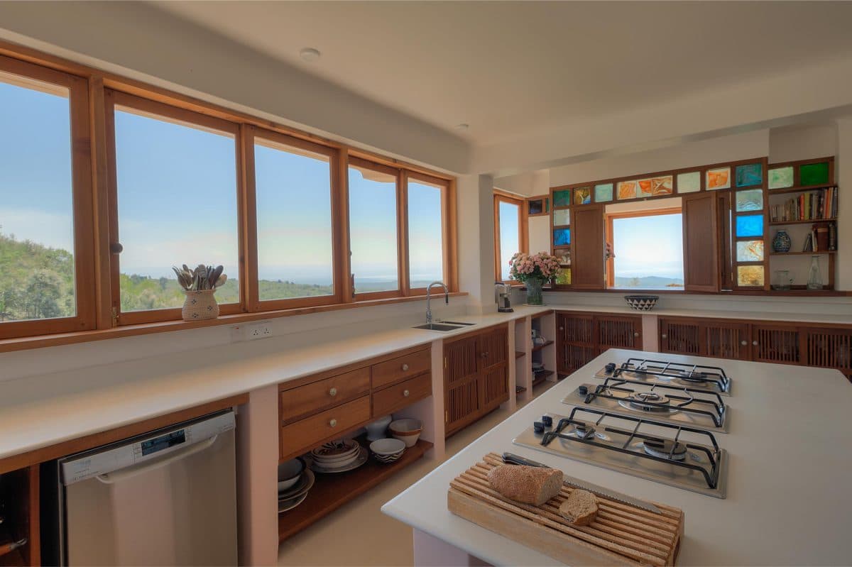 La Maison Bleue Naivasha — kitchen island and cooktop with panoramic valley windows