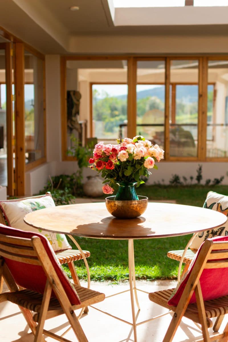 La Maison Bleue Naivasha — striped dining chairs by a courtyard window