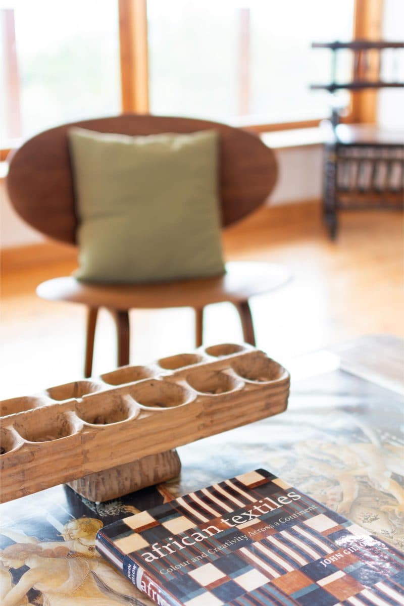 La Maison Bleue Naivasha — coffee table with a wooden Mancala board and African art book