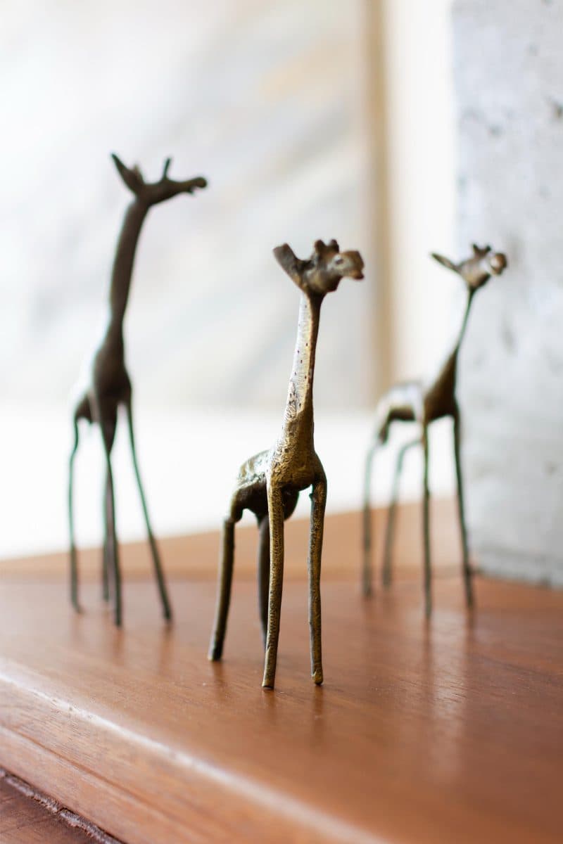 La Maison Bleue Naivasha — bronze giraffe figurines on a polished wood surface