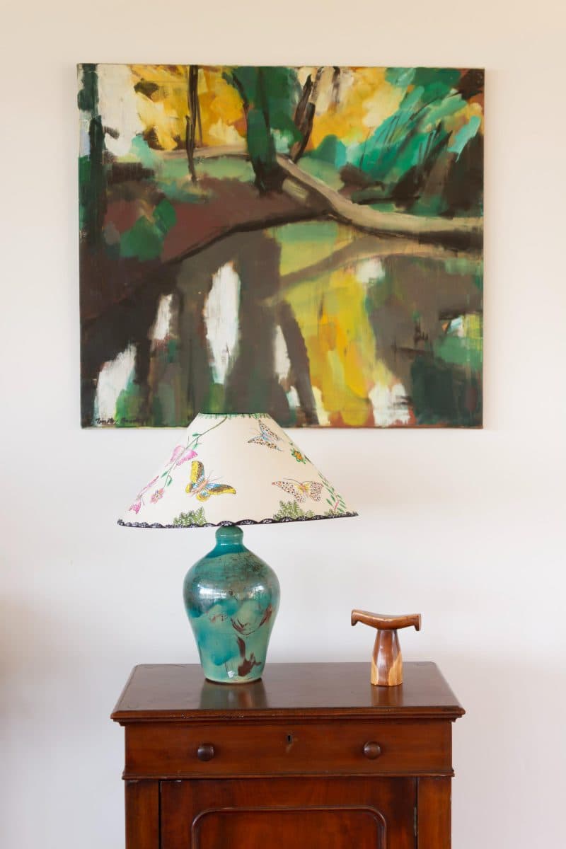 La Maison Bleue Naivasha — dark wood cabinet beneath an abstract painting