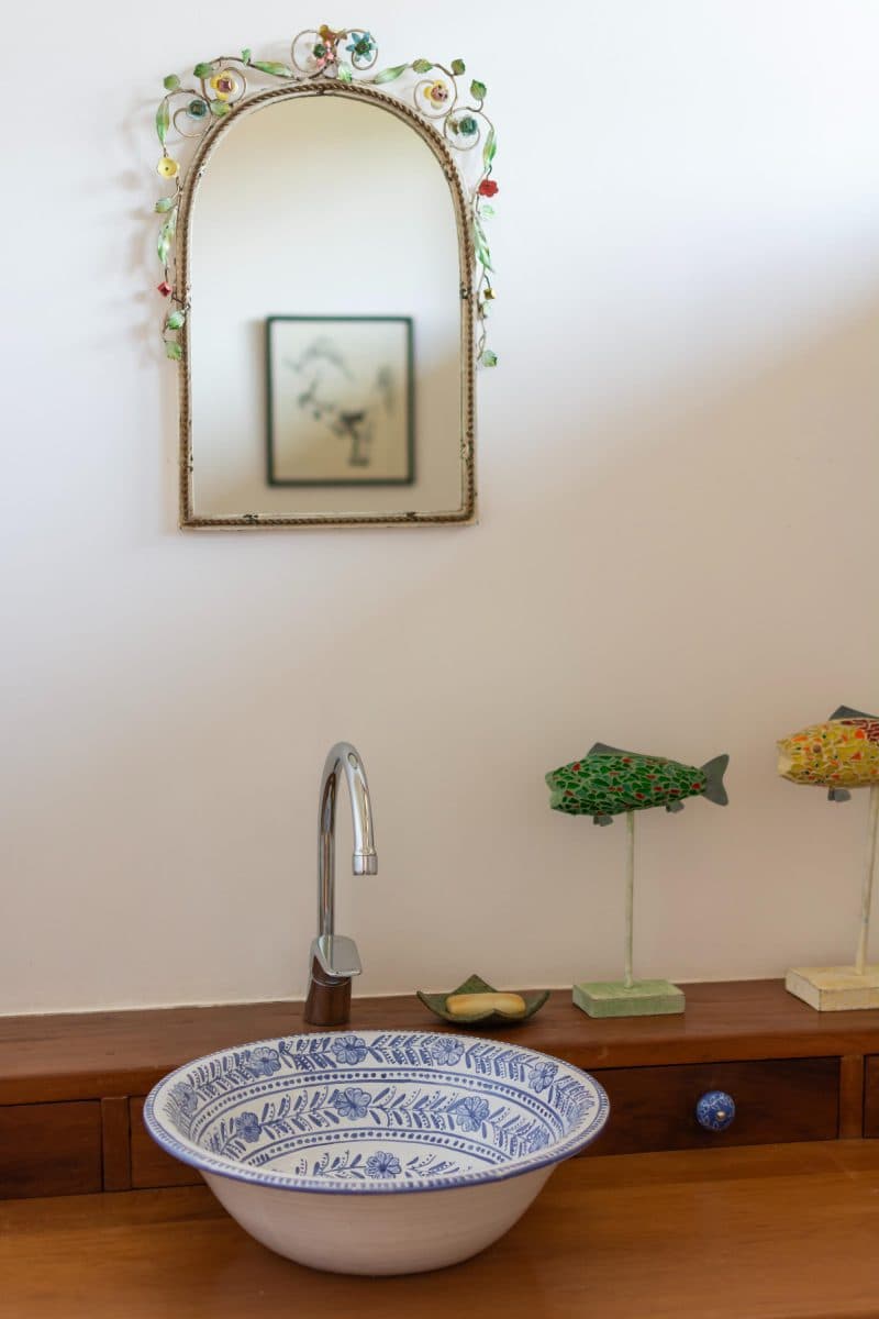 La Maison Bleue Naivasha — blue-and-white floral ceramic washbasin on a wood vanity