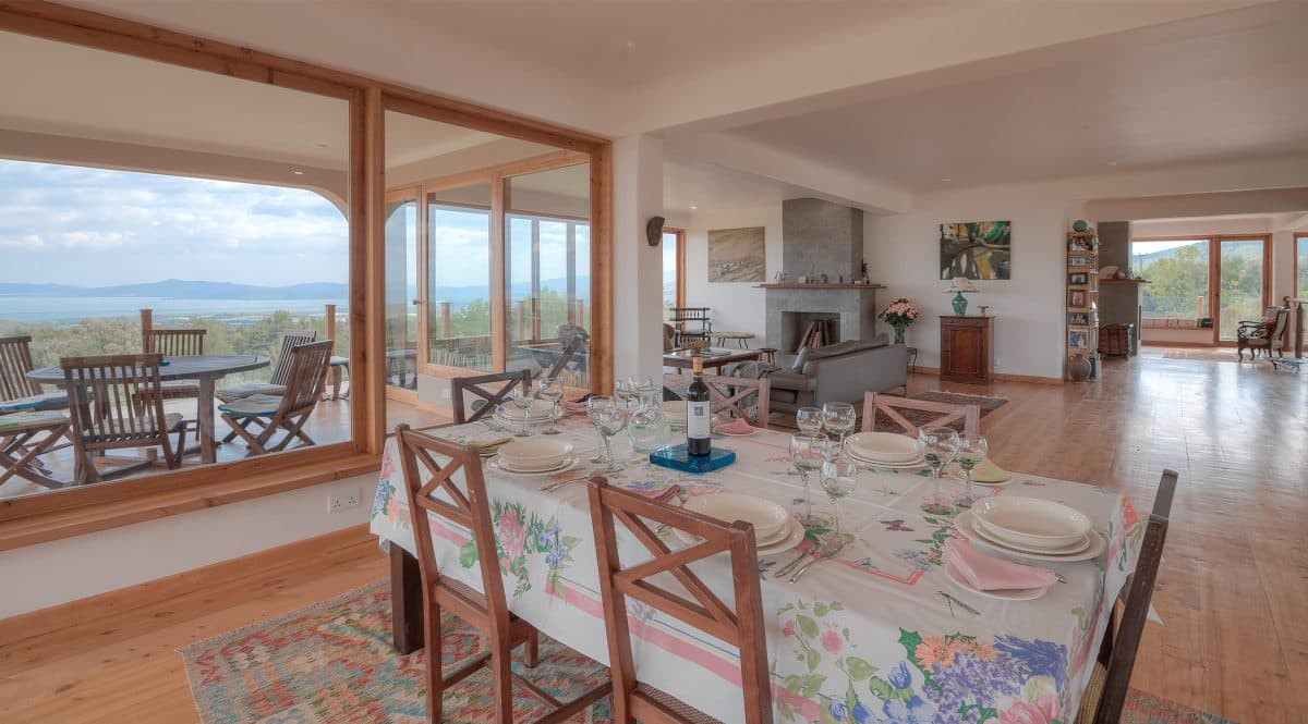 La Maison Bleue Naivasha — dining room looking out through glass doors to the terrace