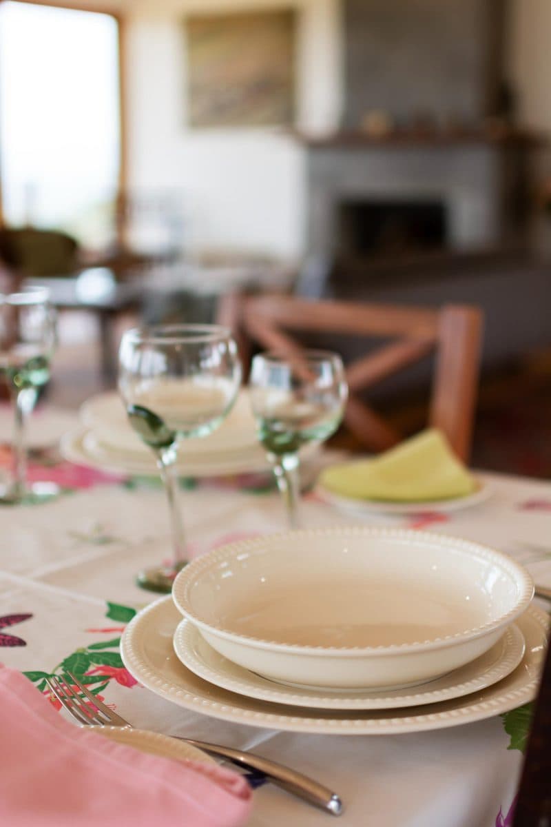 La Maison Bleue Naivasha — table setting with white plates, wine glasses and a pink napkin