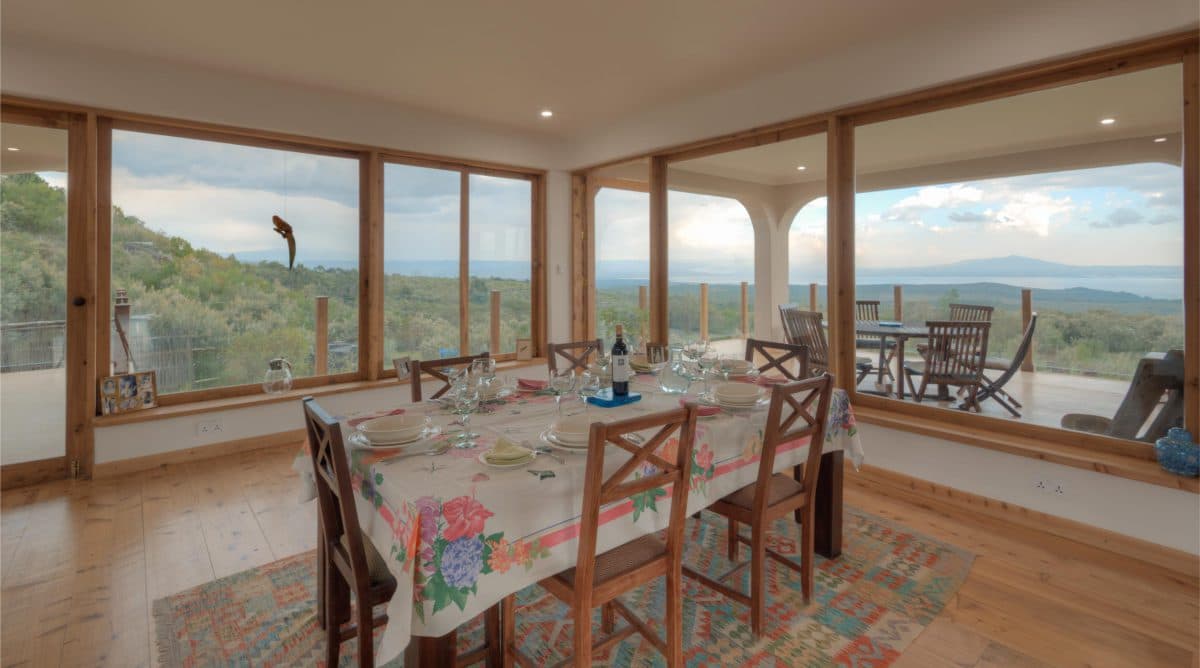 La Maison Bleue Naivasha — view across the set dining table toward the garden windows