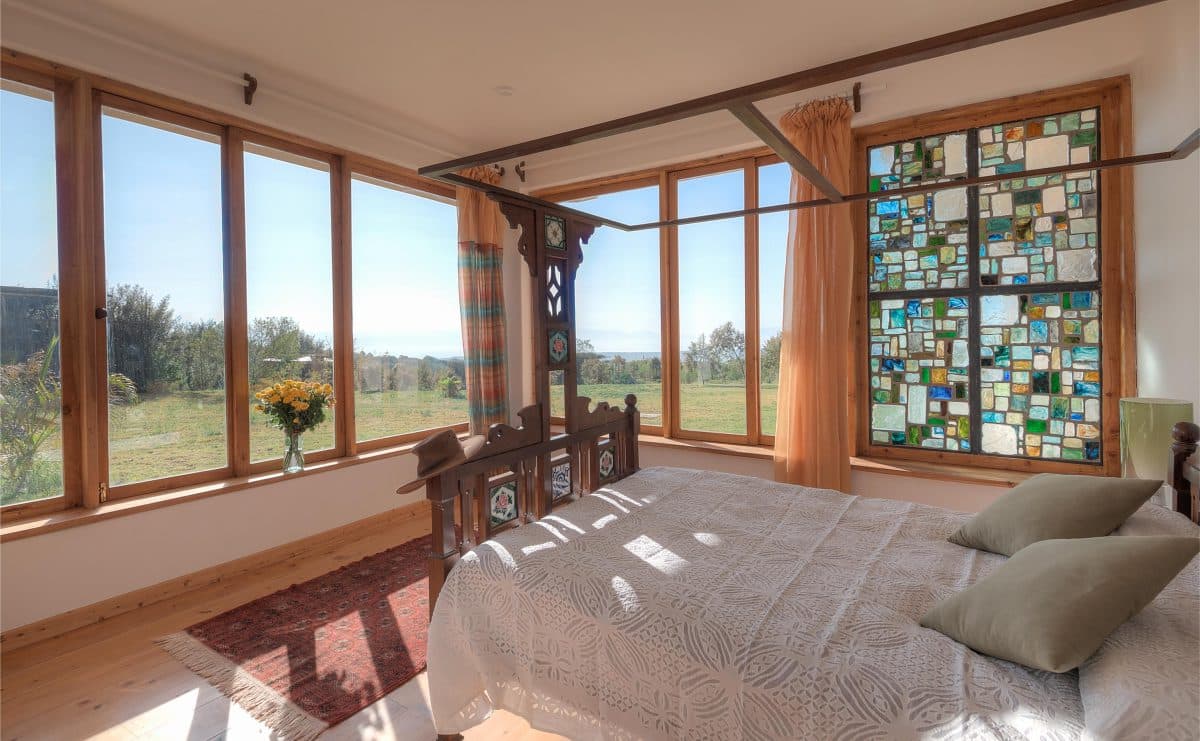 La Maison Bleue Naivasha — bedroom with multi-coloured glass window panes