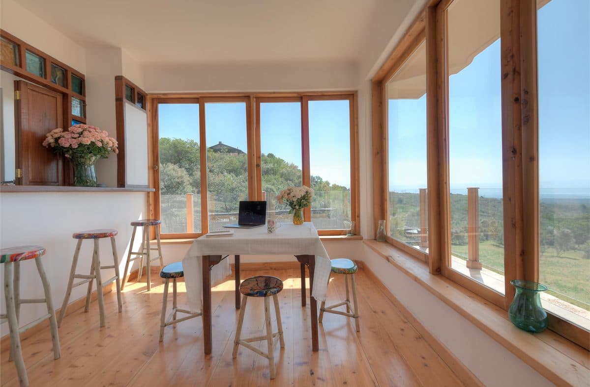 La Maison Bleue Naivasha — breakfast bar and table with wraparound Rift Valley windows