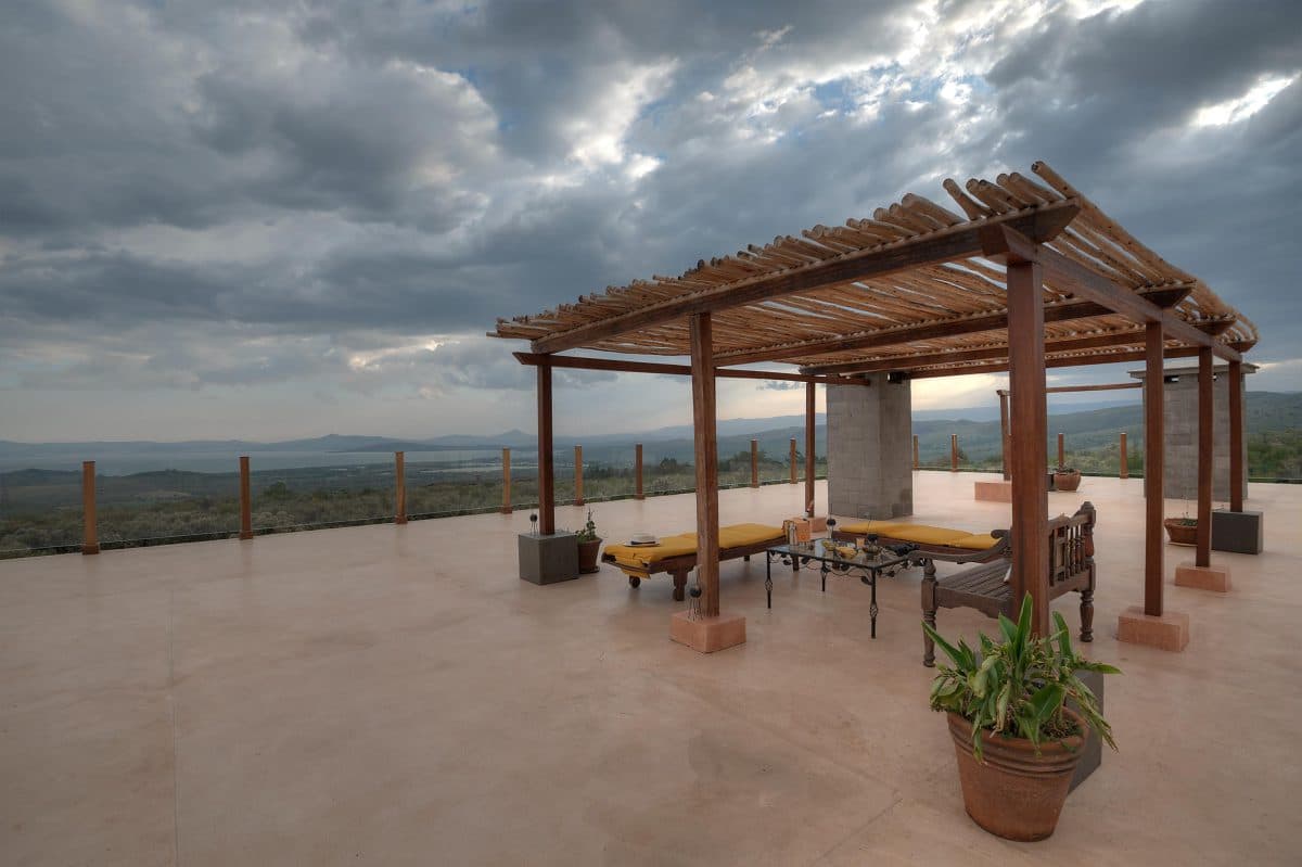 La Maison Bleue Naivasha — stone terrace with wooden pergola and yellow loungers