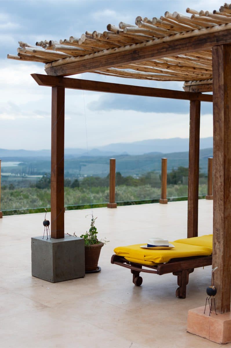 La Maison Bleue Naivasha — pergola beam and yellow lounge chair with a sun hat
