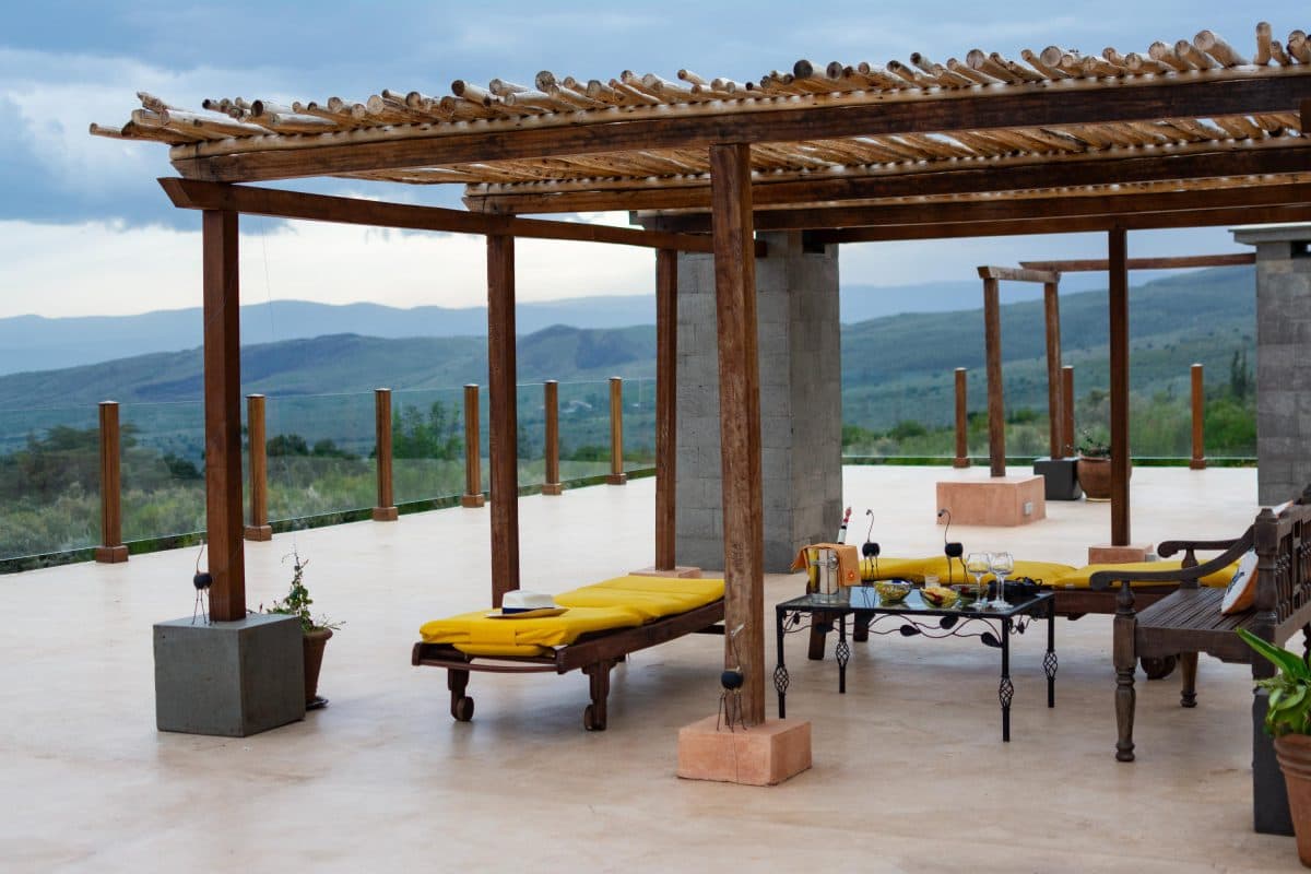 La Maison Bleue Naivasha — shaded terrace seating facing the distant hills