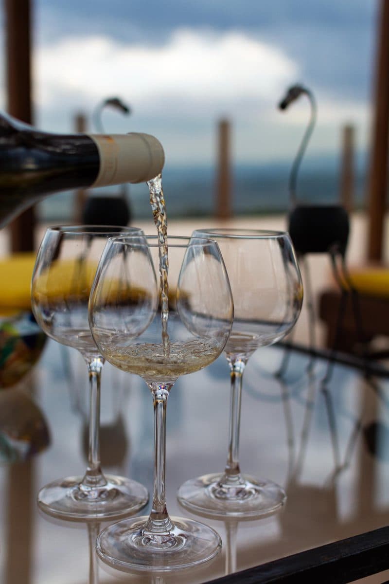 La Maison Bleue Naivasha — pouring white wine on the terrace at dusk